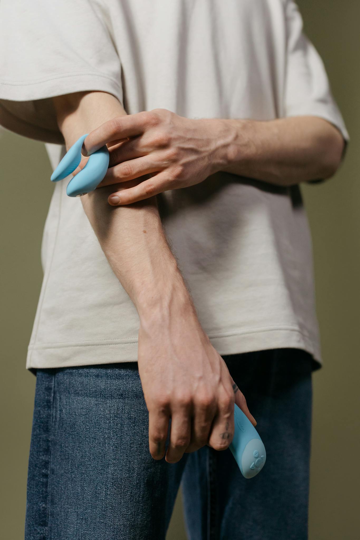 Adult holding a blue vibrator showcasing modern design and intimate wellness.